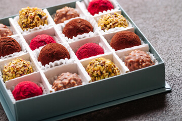A set of truffle sweets with different fillings on a brown background