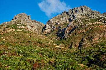 Landscape view of Table Mountain, Cape Town in Western Cape, South Africa. Beautiful scenery of a popular tourist attraction during the day against a cloudy blue sky. Natural landmark for hiking