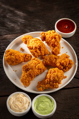Crispy fried chicken with sauces.
