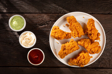 Crispy fried chicken with sauces.