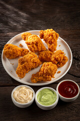 Crispy fried chicken with sauces.