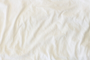 Fototapeta na wymiar Full frame view of crumpled white cotton knit fabric - background concept