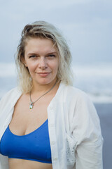 Young woman model xl plus size on the beach, by the ocean, body positivity.