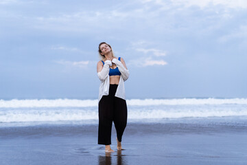 Fototapeta na wymiar Young woman model xl plus size on the beach, by the ocean, body positivity.