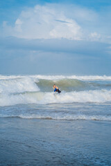 Young attractive woman in a big straw hat on the ocean. Young woman model xl plus size on the beach, by the ocean, body positivity.