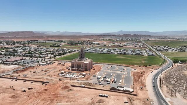 Aerial Red Cliffs Utah Temple St George Utah towards fast motio. Construction residential area. New construction housing economy. The Church of Jesus Christ of Latter-day Saints, LDS Mormon. Religion.