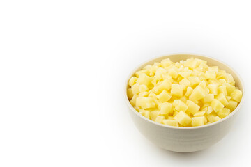 Raw potato cubes in bowl isolated on white background.