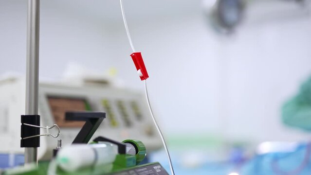 Tube with a switcher from an equipment in surgery room. Close up. Blurred background of operational theatre.