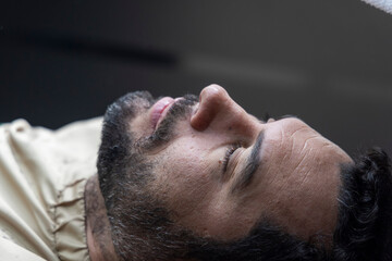 Man lying on barber chair getting ready to shave, Novo Hamburgo barbershop, RS, Brazil