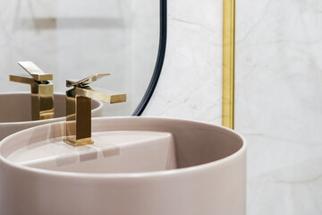 Golden shiny water tap over washbasin in bathroom - obrazy, fototapety, plakaty