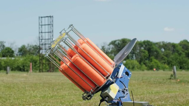 Slow Motion Clay Pigeon from the Side. Bench shooting on plates. V-log Bench shooting on plates. Automatic machine for throwing plates for shooting. Throwing machine for bench shooting.