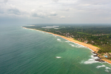 Fototapeta na wymiar Aerial drone of Sandy beach and turquoise water. Hikkaduwa, Sri Lanka.