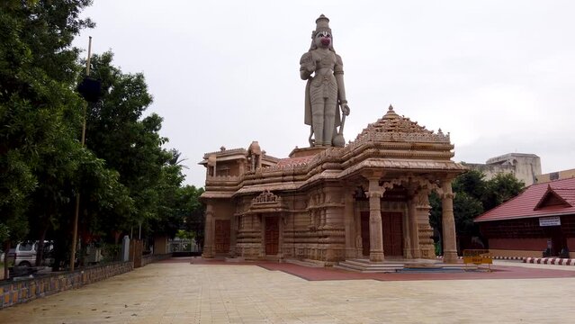 A Divine view of an exquisite Hanuman temple built in sand stone with a large statue of the deity on top at Mysuru in Karnataka, India.
