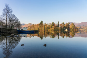 Fototapeta na wymiar Derwentwater lake with reflection and boat pier in Lake District, Cumbria. England
