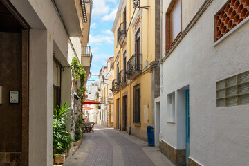 Fototapeta na wymiar A narrow picturesque street in the Spanish coastal town of Tossa de Mar, on the Costa Brava coast of the Catalonian region of Southern, Spain.