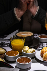 table with breakfast cup with coffee with milk jam orange juice butter dulce de leche