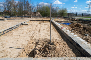 Shovel placed in sand used for digging in house foundation