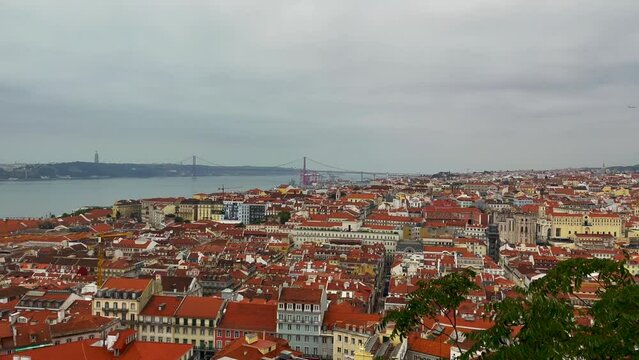 View of the historical Lisbon Baixa downtown ,Tagus River, and The Ponte 25 de abril bridge from the Sao Jorge St. George Castle in Lisbon, Portugal 4K