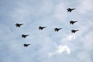 MIG-29SMT fighters fly in the sky over Red Square during the dress rehearsal of the parade...