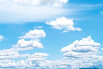 White clouds patterns on vast bright blue sky  with light breeze air background