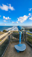 Public viewing binoculars on the headland at Cape Byron, Byron Bay tourist destination in Australia