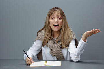 Shocked excited young blonde student lady freelancer in warm sweater open mouth have idea insight...