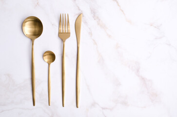 Clean golden metal cutlery