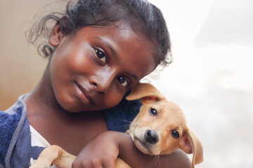 Portrait of Indian little girl with small pet dog
