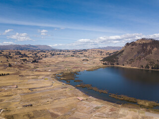 Aerial view of Huaypo Lake. Water source in the high Andes of Cusco Peru. Sunny day in Andean rural landscape.