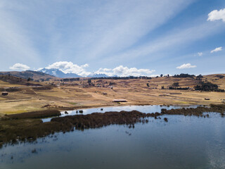 Aerial view of Huaypo Lake. Water source in the high Andes of Cusco Peru. Sunny day in Andean rural landscape.