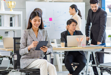 Obraz premium Portrait shot Asian young successful friendly businesswoman in formal suit sitting smiling holding tablet while male businessman and female colleagues working brainstorming together in meeting room