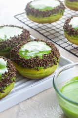 Donat matcha green tea or matcha green tea donuts. donuts with matcha glaze and grated chocolate. fresh Homemade food. 