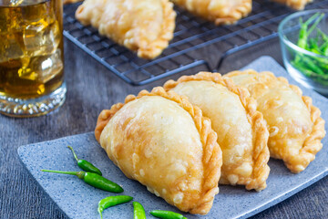 pastel goreng, a snack containing meat and vegetables cooked by frying. It has a crunchy and savory texture. pastels are easy to find in Indonesian traditional markets