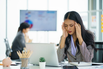 Asian businesswoman feeling stressful and headache after working for a long time, Office syndrome concept.