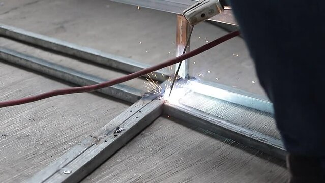 Soldador hombre trabajador de la soldadura de la estructura de vigas de acero. V&iacute;deo 
Industrial HD