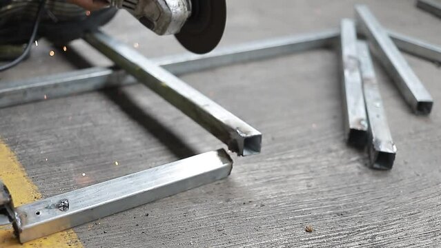 Hombre cortando acero con maquina cortadora en fabrica industrial. toma detalle.