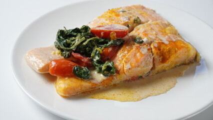 Salmon Fillet  with spinach and cherry tomatoes in creamy sauce