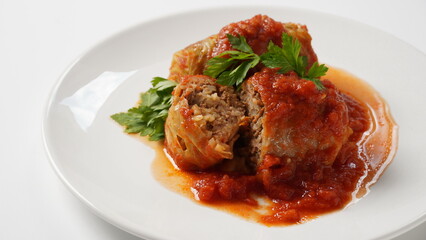 Stuffed cabbage rolls with tomato sauce and herbs