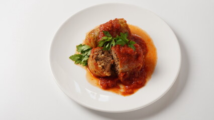 Stuffed cabbage rolls with tomato sauce and herbs