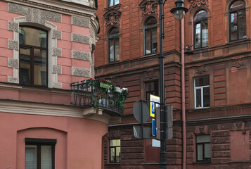 City street in the evening. Historical facades of houses. Balconies with flowers.