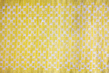Old fabric yellow pattern. Shabby old fabric bedspread texture background. - obrazy, fototapety, plakaty