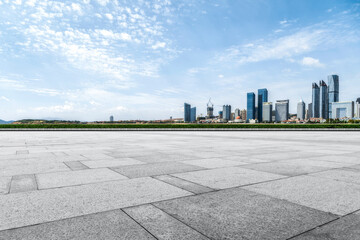 Perspective view of empty concrete tiles floor of rooftop with city skyline