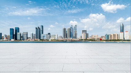 Perspective view of empty concrete tiles floor of rooftop with city skyline