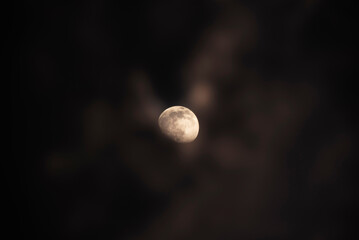 Moon in cloudy dark night sky