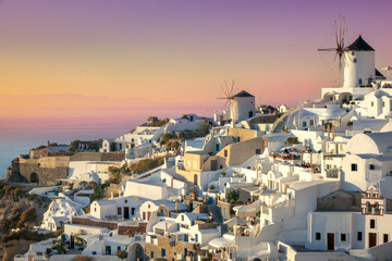 Santorini at Sundown. The famous town of Oia in the sunset. Romantic holidays. Oia, Santorini, Greece
