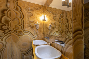 Interior of a luxury hotel bathroom with marble walls