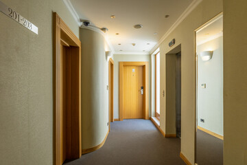 Interior of a hotel corridor with doors with room nummbers