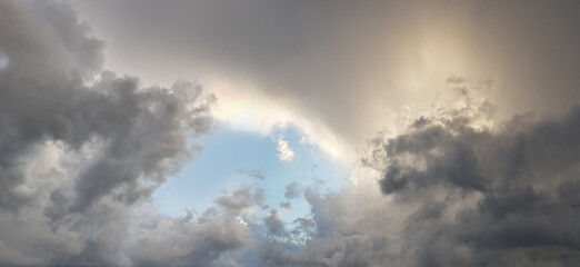 Fototapeta na wymiar Dramatic storm clouds with sunlight. Blue sky after storm