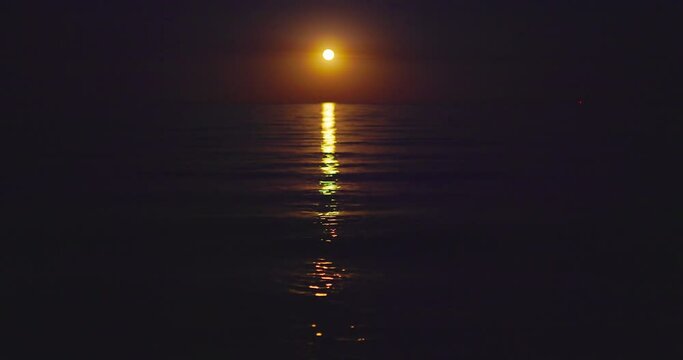 Sea twilight. Full moon rising over ripple ocean waves, romantic moonlight over water