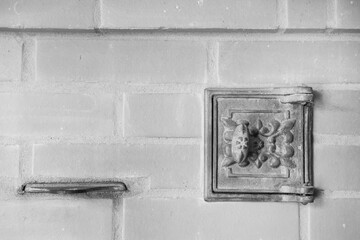 cast-iron oven door against the background of a brick oven wall as colorless background